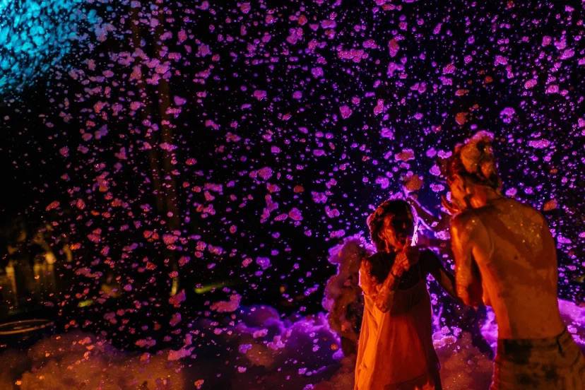 A foam party after dark, lit like a music video — a real kids birthday party in Bali