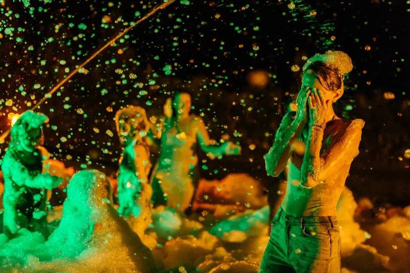 A foam party after dark, lit like a music video — photo 6